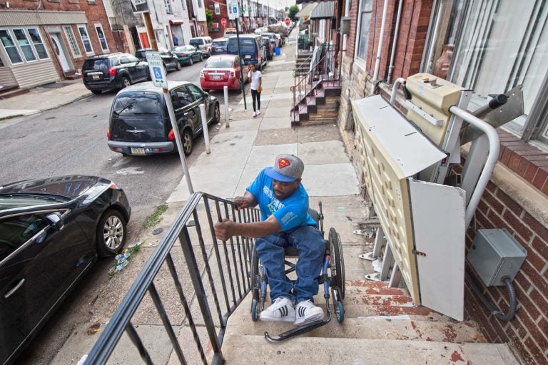 Rodney Whitmore of South Philadelphia was shot and paralyzed in 1995. When his wheelchair lift is broken, he tilts his wheelchair backward and lowers himself down his front steps so he can get to work.