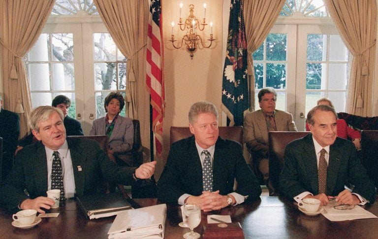 Then-House Speaker Newt Gingrich gestures toward President Bill Clinton, as then-Senate GOP leader Bob Dole sits to the right. They met to try to work through the government shutdown in late 1995 to early 1996. (Greg Gibson/AP)