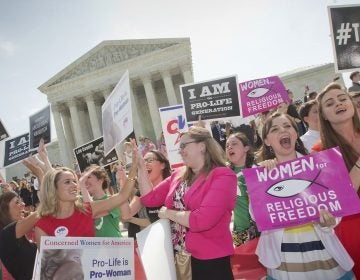 In this 2014 photo, demonstrators react to hearing the Supreme Court's decision on the Hobby Lobby birth control case outside the Supreme Court in Washington. A judge in California has blocked implementation of a Trump administration policy that would let more employers decline to offer birth control coverage on religious or moral grounds.
