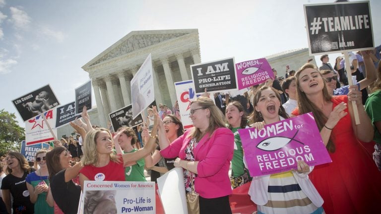 In this 2014 photo, demonstrators react to hearing the Supreme Court's decision on the Hobby Lobby birth control case outside the Supreme Court in Washington. A judge in California has blocked implementation of a Trump administration policy that would let more employers decline to offer birth control coverage on religious or moral grounds.
