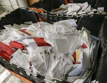 Letters wait in bins for sorting at the main post office in Omaha, Neb. The price of a Forever stamp has increased by 10 percent as the U.S. Postal Service contends with billions of dollars in annual losses. (Nati Harnik/AP)