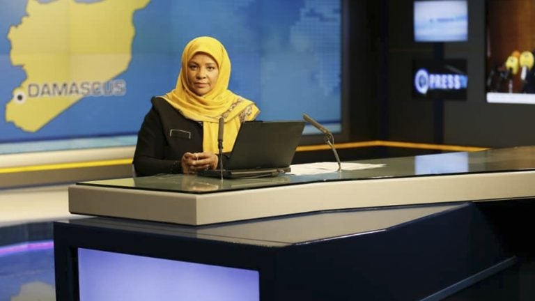 American-born news anchor Marzieh Hashemi sits in a studio in Tehran where she works for Iran's state television. She was arrested Sunday during a visit to the U.S., her family says. She is testifying behind closed doors to a grand jury in Washington, D.C., in an unspecified case, a U.S. judge said Friday. (Press TV/AP)