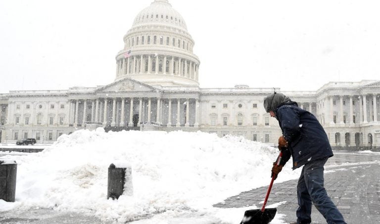 Aaron Rowe of the Architect of the Capitol’s office, which is not affected by the partial government shutdown, shovels snow left by a winter storm on the U.S. Capitol’s plaza.  (REUTERS/Mike Theiler)