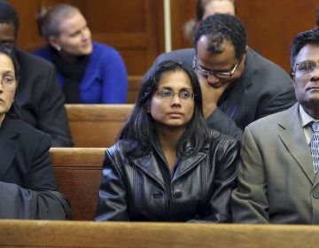 Annie Dookhan, (center), pictured with her family in a Boston courtroom Nov. 22, 2013, after she pleaded guilty to tampering with evidence. Dookhan was a state chemist. (David L. Ryan/AP/The Boston Globe)