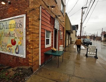 In this March 1, 2018 photo, a customer leaves Dylamatos Market owned by Dianne Shenk in the Hazelwood neighborhood of Pittsburgh. About a quarter of Shenk's customers pay with benefits from the federal Supplemental Nutrition Assistance Program. (Gene J. Puskar/AP)