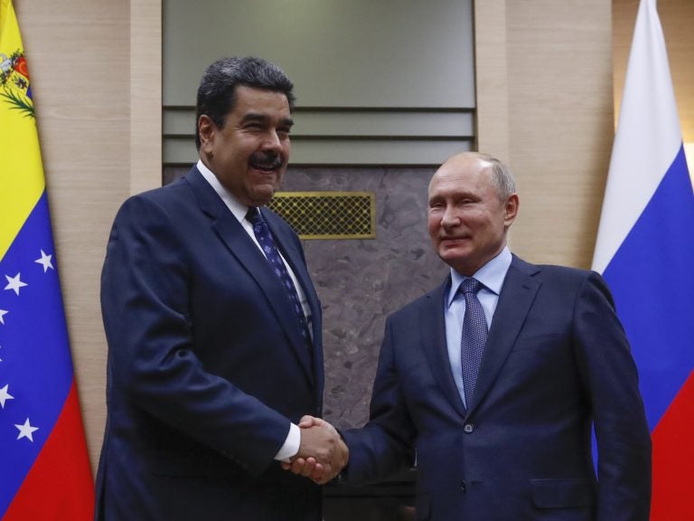 Russian President Vladimir Putin shakes hands with Venezuela's Nicolás Maduro during a meeting outside Moscow on Dec. 5. (Maxim Shemetov/AFP/Getty Images)