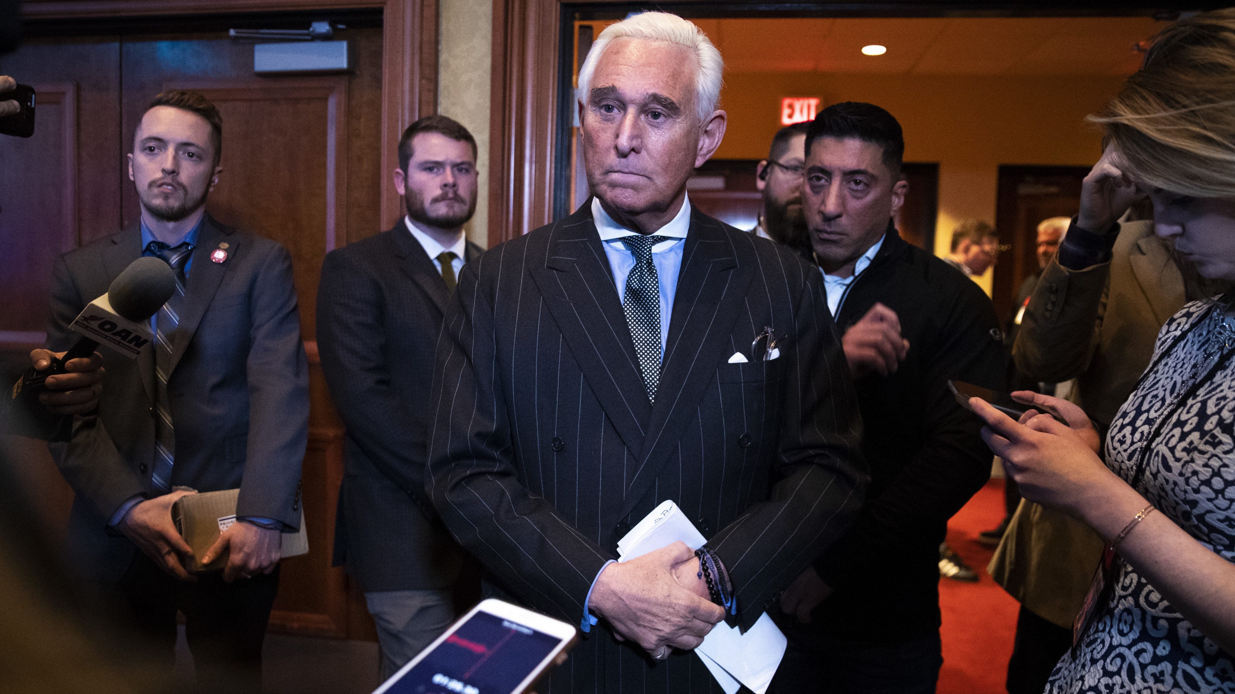 Political strategist Roger Stone talks to reporters after speaking at the American Priority Conference, December 6, 2018 in Washington, D.C.