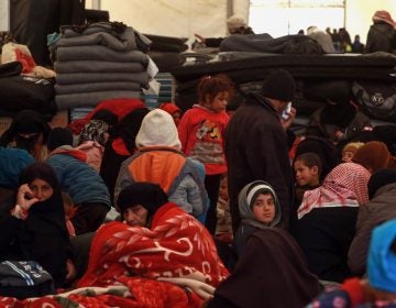 Displaced Syrians gather inside a tent in the al-Hol camp in northeastern Syria on Dec. 8. People fled towns where the U.S.-led coalition is fighting the last remnants of ISIS. (Delil Souleiman/AFP/Getty Images)