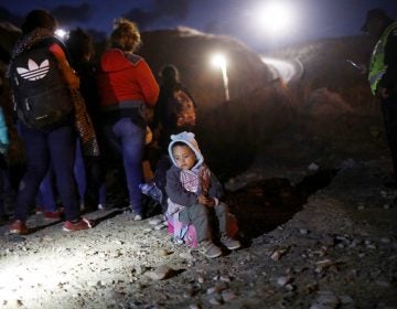 A group of Honduran migrants are detained along the U.S.-Mexico border by Mexican police after attempting to cross the border barrier into the U.S. (Mario Tama/Getty Images)