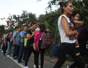 Honduran migrants wait in line to cross over the border checkpoint into Guatemala in Agua Caliente, Honduras. A new caravan of at least several hundred Hondurans has set off toward the United States on foot or in vehicles. Some have already crossed into Guatemala. (Mario Tama/Getty Images)