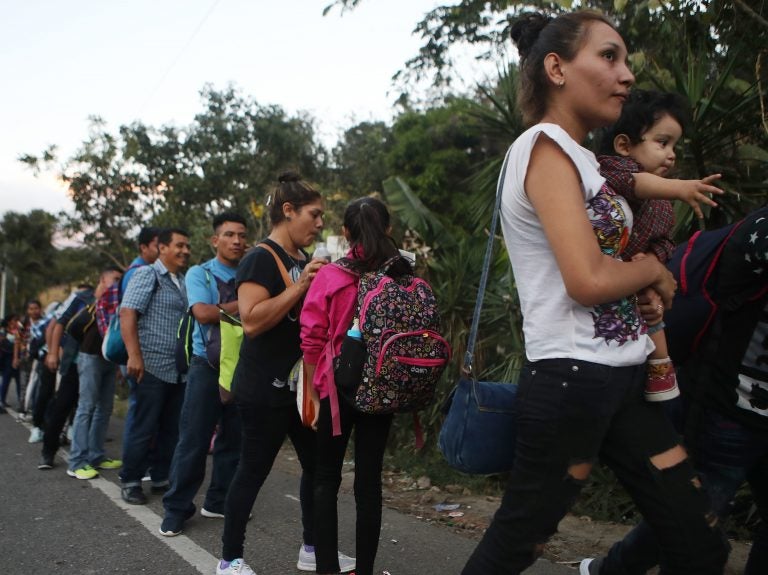 Honduran migrants wait in line to cross over the border checkpoint into Guatemala in Agua Caliente, Honduras. A new caravan of at least several hundred Hondurans has set off toward the United States on foot or in vehicles. Some have already crossed into Guatemala. (Mario Tama/Getty Images)