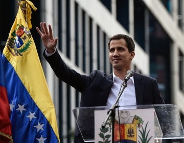 Venezuela's National Assembly head Juan Guaidó waves during a mass opposition rally, during which he declared himself the country's acting president on Jan. 23. (Federico Parra/AFP/Getty Images)
