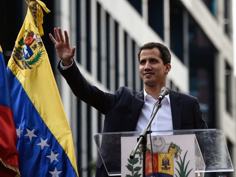 Venezuela's National Assembly head Juan Guaidó waves during a mass opposition rally, during which he declared himself the country's acting president on Jan. 23. (Federico Parra/AFP/Getty Images)