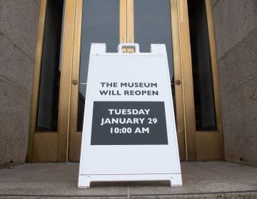 A sign at the entrance of the Smithsonian National Museum of Natural History in Washington, D.C., says the museum will reopen Tuesday. The shutdown reduced federal spending by $18 billion, although most of that will be recouped now that the government has reopened, according to a new report.
(Saul Loeb/AFP/Getty Images)