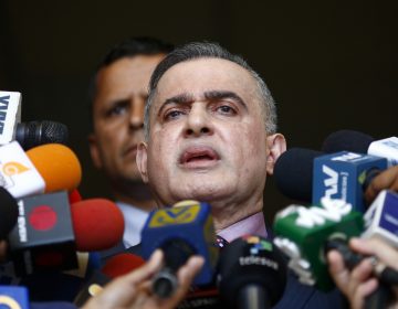 Venezuela's top prosecutor, Tarek William Saab, talks to reporters in Caracas on Tuesday. He announced that Juan Guaidó, now President Nicolás Maduro's most prominent opponent, is barred from leaving the country because of an investigation. (Marco Bello/Getty Images)