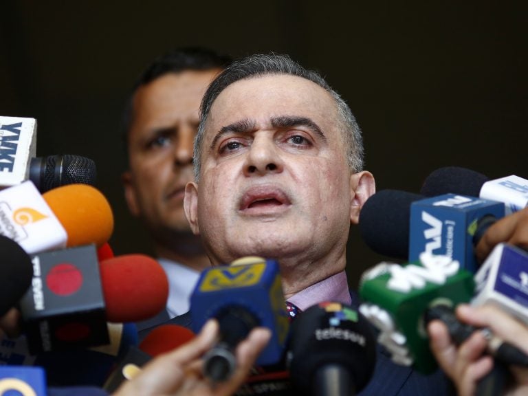 Venezuela's top prosecutor, Tarek William Saab, talks to reporters in Caracas on Tuesday. He announced that Juan Guaidó, now President Nicolás Maduro's most prominent opponent, is barred from leaving the country because of an investigation. (Marco Bello/Getty Images)