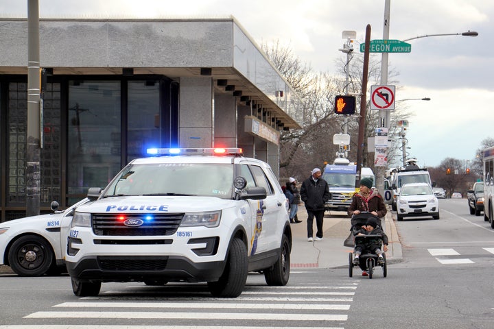 Police block traffic at Broad Street and Oregon Avenue during a manhunt for a man from Delaware. (Emma Lee/WHYY)