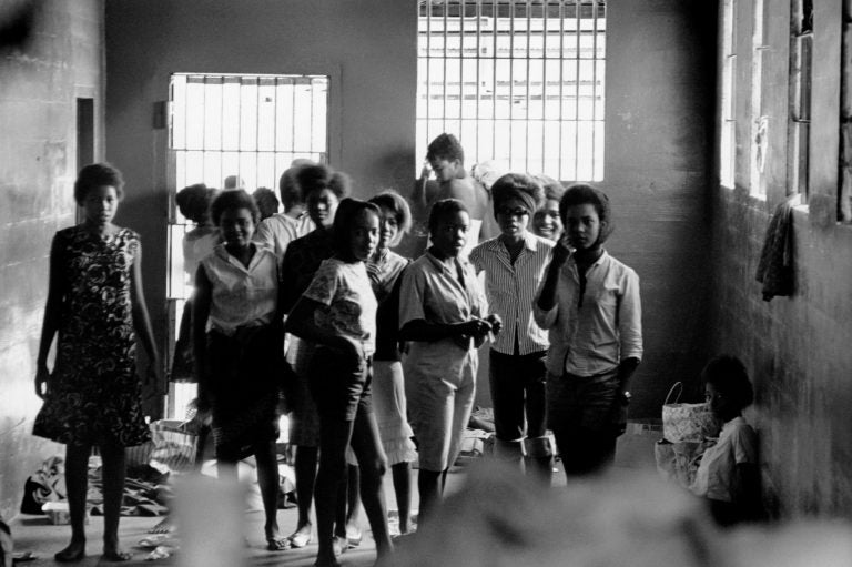 In August 1963, African-American girls were held in a Georgia stockade after being arrested for demonstrating segregation. Left to right: Melinda Jones Williams (13), Laura Ruff Saunders (13), Mattie Crittenden Reese, Pearl Brown, Carol Barner Seay (12), Annie Ragin Laster (14), Willie Smith Davis (15), Shirley Green (14), and Billie Jo Thornton Allen (13). Sitting on the floor: Verna Hollis (15). (Danny Lyon)