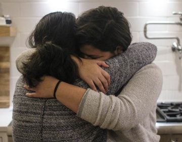 Maria Rivas and her 15-year-old daughter, Emily, embrace after their StoryCorps interview last month. (Mia Warren/StoryCorps)