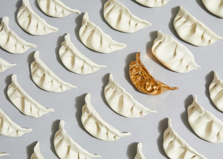 Artist Stephanie Shih remembers making pork-filled dumplings with her family and started her art project by sculpting six of them out of porcelain. She's now made 600. (Robert Bredvad/NPR)