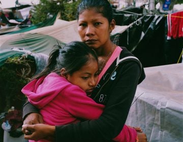 Karen Paz hugs her daughter, Liliana Saray, 9. They are from San Pedro Sula, Honduras. 