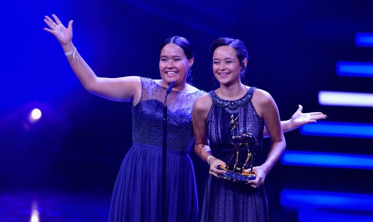 Teenage sisters Melati and Isabel Wijsen of Bali have received many honors for their efforts to ban plastic bags. Above: They accept the 2017 