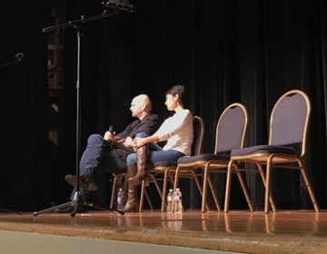 Fetterman onstage with Patty Kim, the Democrat who represents Harrisburg in the state House. (Katie Meyer/WITF)