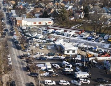 Law enforcement personnel gather near the scene of a shooting at an industrial park in Aurora, Ill., on Friday, Feb. 15, 2019. (Bev Horne/Daily Herald via AP)