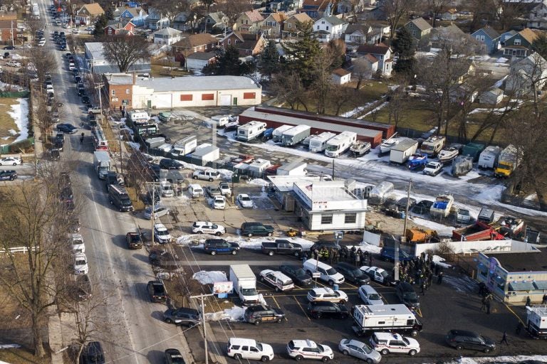 Law enforcement personnel gather near the scene of a shooting at an industrial park in Aurora, Ill., on Friday, Feb. 15, 2019. (Bev Horne/Daily Herald via AP)