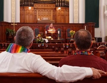 Daron Smith, (left), and his husband, Chris Finley, (right), worship at a Sunday morning service at Lafayette Park United Methodist Church in St. Louis, Mo. Smith, a lifelong United Methodist, said he feels hopeful ahead of a vote on LGBTQ ordination and same-sex weddings in the church. (Shahla Farzan/St. Louis Public Radio)