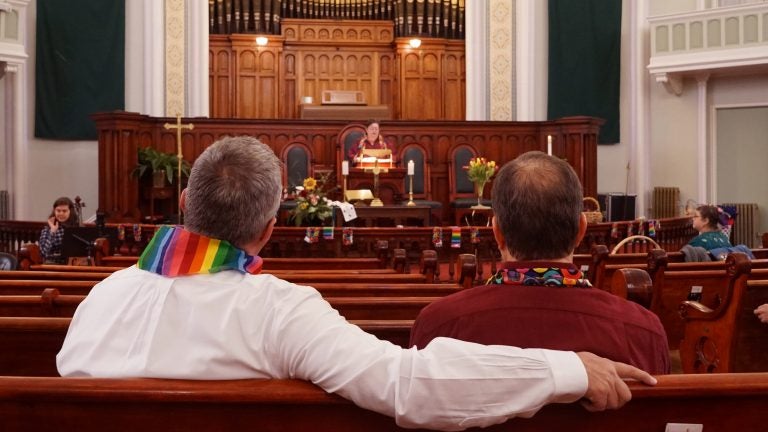 Daron Smith, (left), and his husband, Chris Finley, (right), worship at a Sunday morning service at Lafayette Park United Methodist Church in St. Louis, Mo. Smith, a lifelong United Methodist, said he feels hopeful ahead of a vote on LGBTQ ordination and same-sex weddings in the church. (Shahla Farzan/St. Louis Public Radio)