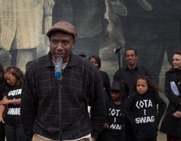 Artist Willis Humphrey. better known as NOMO, speaks at the dedication of his mural, 