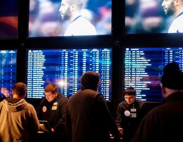 Prospective bettors place their wagers on sports events at the Sugar House Casino. (Brad Larrison for WHYY)