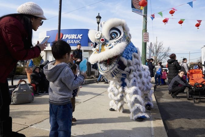 Performers take photos and play with children at the 2019 Chinese New Year Festival in Northeast Philadelphia. (Natalie Piserchio for WHYY)