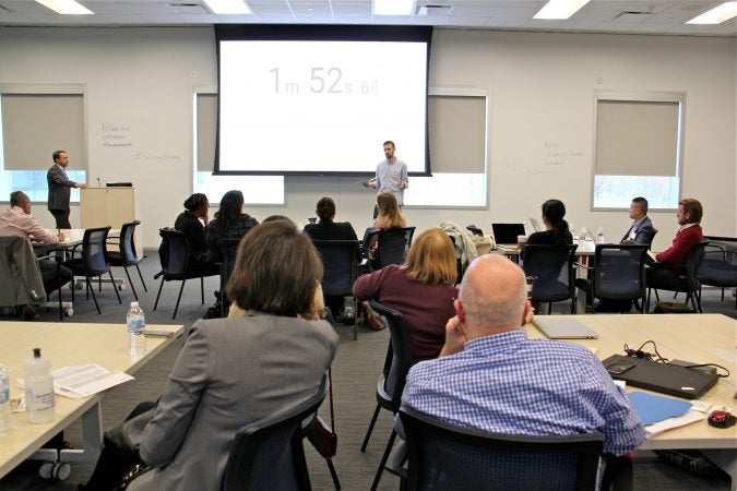 Jarrett Stein, representing The Rebel Market, delivers a timed, 5-minute pitch for a project that would provide fresh, healthy affordable snacks to kids while employing high school students part time after school. (Emma Lee/WHYY)