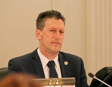 A person stands at a podium.