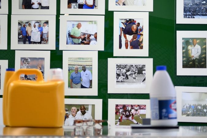 Pictures on the wall remind James Betterson, a former Philadelphia Eagles running back of his football career. He now owns BetterClean Laundry in Northeast Philadelphia. (Bastiaan Slabbers for WHYY)