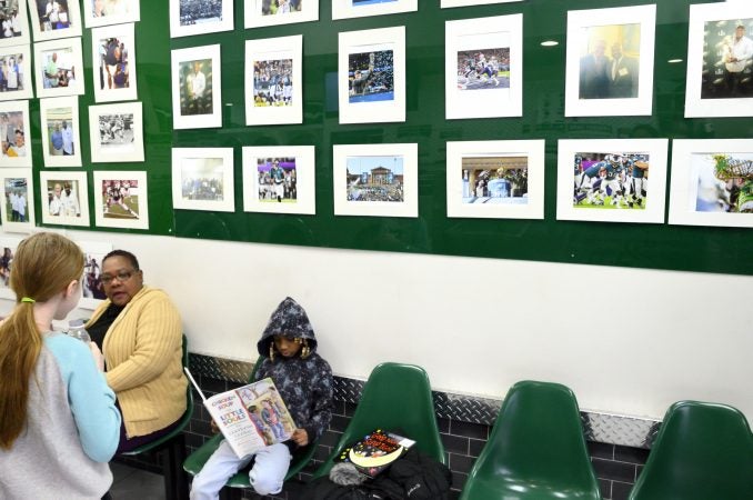 Egypt, 7, reads a book at the laundry library while waiting at the laundromat owned and operated by James Betterson, in Northeast Philadelphia on Feb. 15. (Bastiaan Slabbers for WHYY)