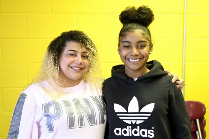 Delilah Santiago and Lankenau freshman Amunique Watson pose at an end-of-year banquet hosted by Coach Lurline Jones at the cafeteria of MLK Highschool, in Northwest Philadelphia, Pa., on February 19, 2019. (Bastiaan Slabbers for WHYY)