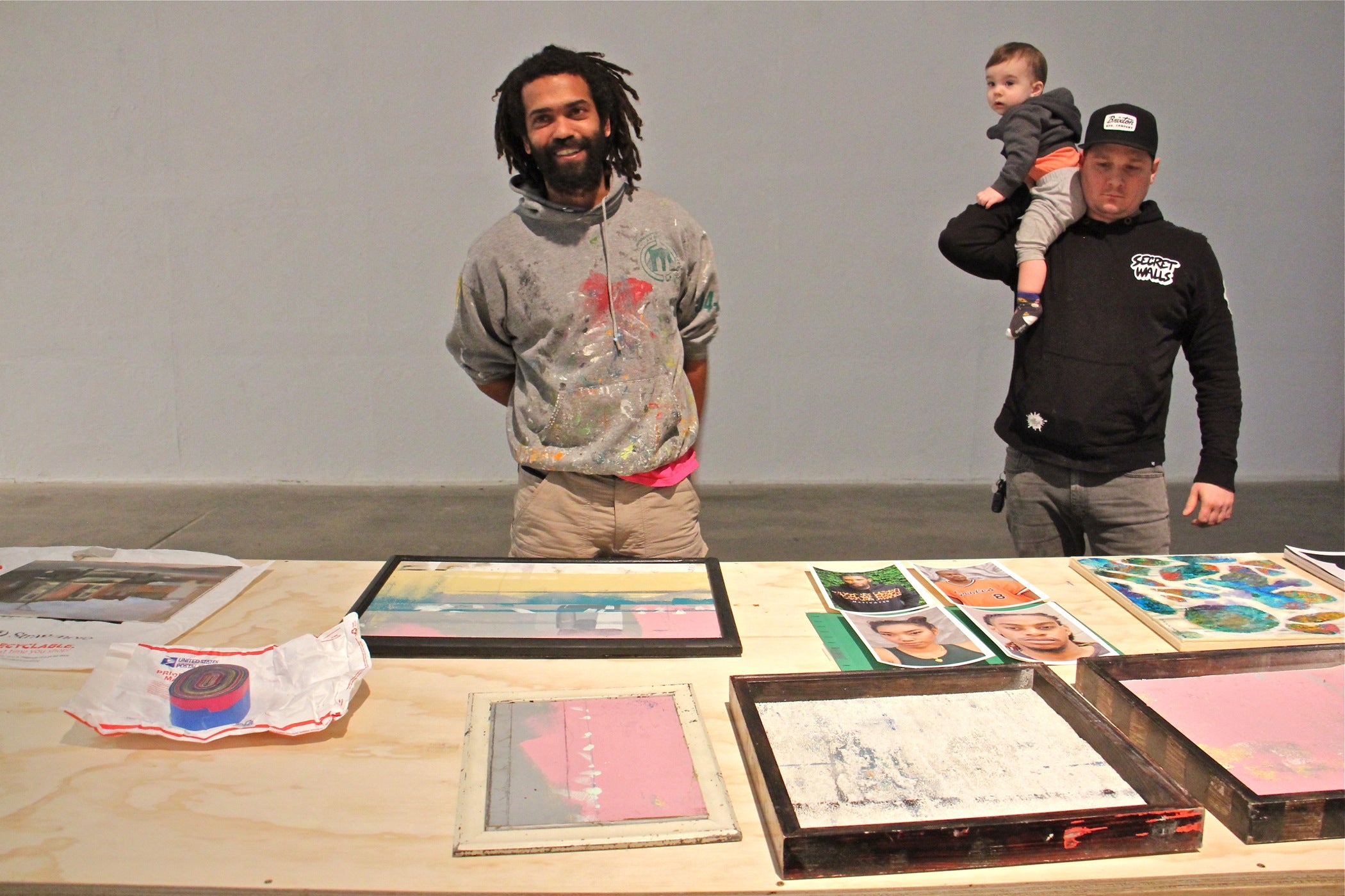 Keir Johnston (left), of the Philadelphia arts collective Amber Art and Design, collects donated works of art that will be sold to benefit the family of Willis "Nomo" Humphrey, who died in November at age 44. He is joined by Philadelphia artist Ben Howard, who dropped off some donated works at the Crane Arts Building. 