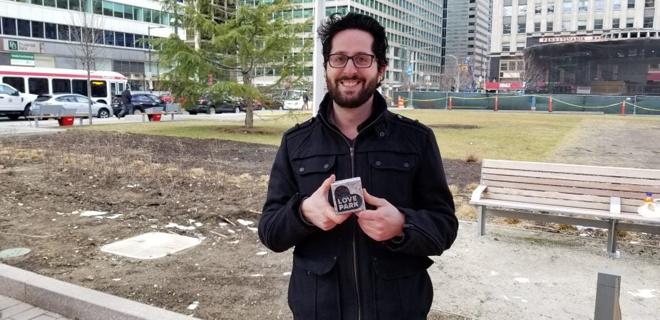 Andrew Emma, manager of Love Park, holds up one of the new granite paperweights (Tom MacDonald, WHYY)