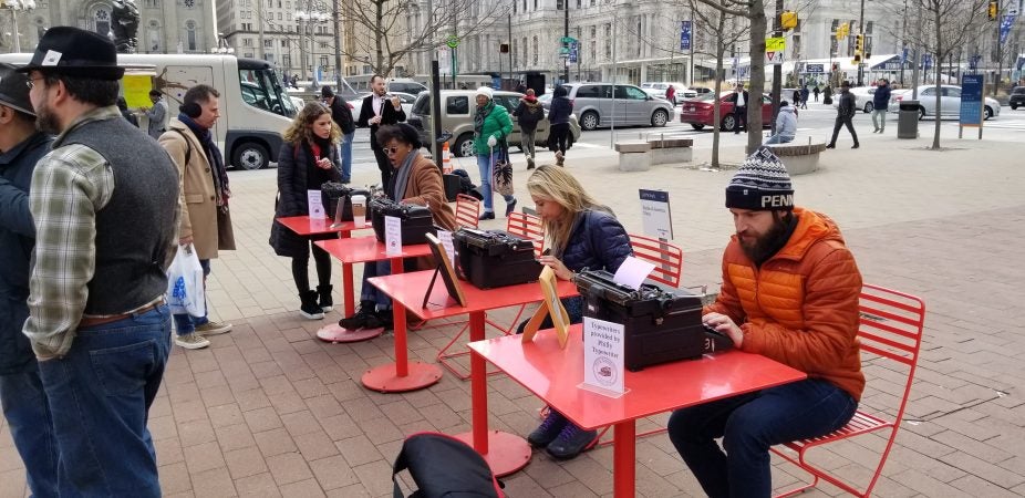 Visitors to LOVE Park type love letters on vintage typewriters. (Tom MacDonald/WHYY)