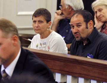 Cathy Katsnelson, second left, and Mark Katsnelson, second right, listen to 