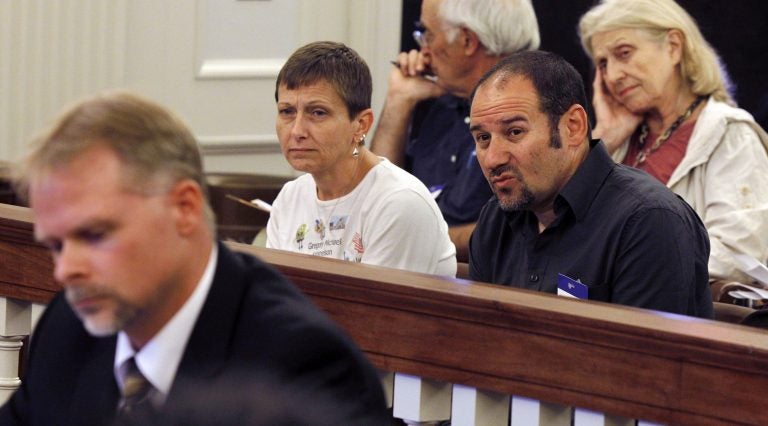 Cathy Katsnelson, second left, and Mark Katsnelson, second right, listen to 