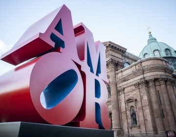 This photo shows Robert Indiana's AMOR sculpture in a park outside Philadelphia's Cathedral Basilica of Saints Peter and Paul, Friday, Dec. 2, 2016. (AP Photo/Michael R. Sisak)