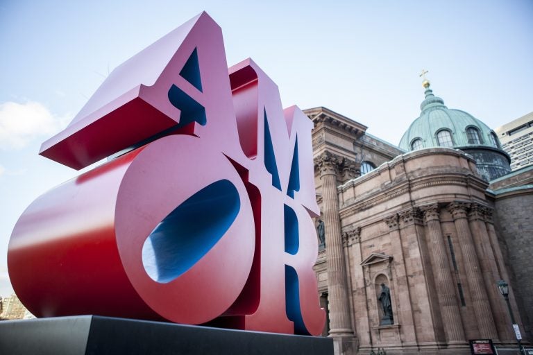 This photo shows Robert Indiana's AMOR sculpture in a park outside Philadelphia's Cathedral Basilica of Saints Peter and Paul, Friday, Dec. 2, 2016. (AP Photo/Michael R. Sisak)