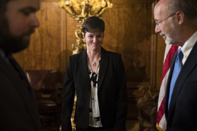 Teresa Miller, center, accompanied by Gov. Tom Wolf, right, depart a news conference at the Pennsylvania Capitol in Harrisburg, Pa., Tuesday, May 23, 2017. (Matt Rourke/AP Photo)