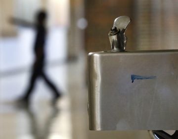 A student walks in the hallway past a water fountain at Noble School in Detroit, Tuesday, Sept. 4, 2018. (Paul Sancya/AP Photo)