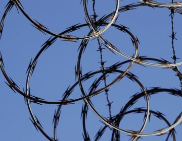 In this Tuesday, Oct. 23, 2018 photo, barbed wire lines the top of a wall at the deactivated House of Correction in Philadelphia. (Matt Rourke/AP Photo)