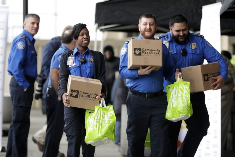 Transportation Security Administration employees carry boxes of non perishables and bags of produce received from the Community Food Bank at a drive at Newark Liberty International Airport to help government employees who are working without pay during the partial government shutdown, Wednesday, Jan. 23, 2019, in Newark, N.J. (Julio Cortez/AP Photo)